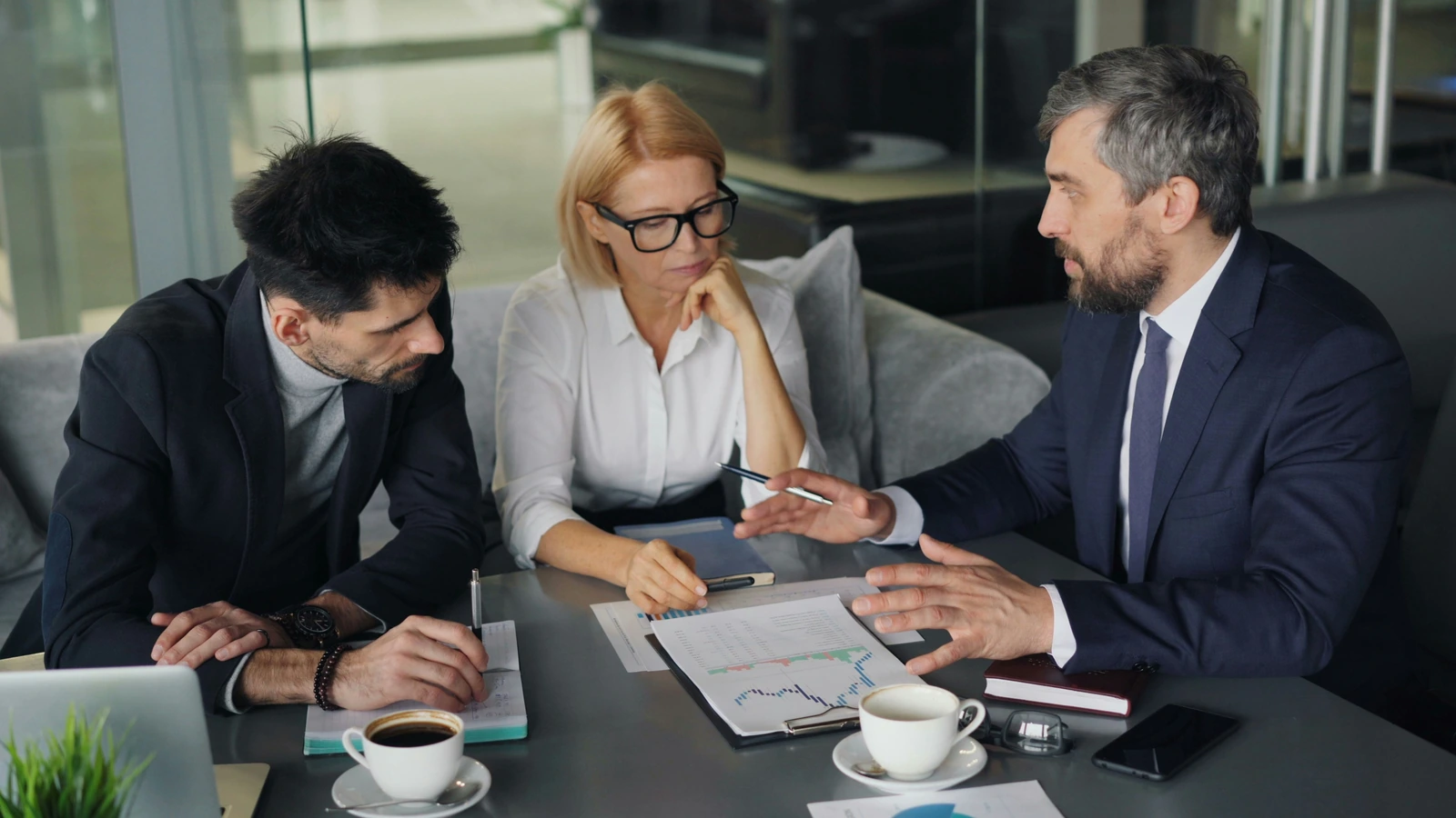 Business professionals reviewing financial information during a meeting